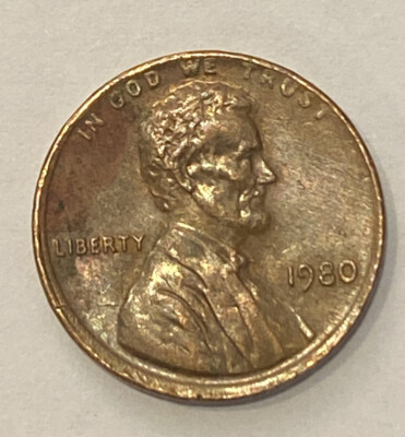 1980 penny with off-center strike error showing missing design area and visible blank planchet crescent with date still legible